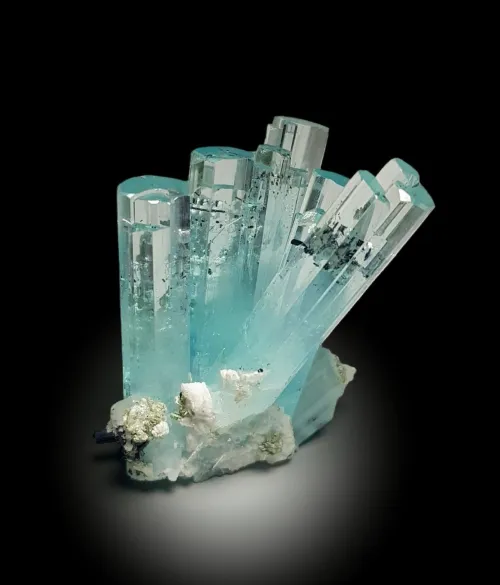 Close-up comparison of bezel versus prong settings on aquamarine gems