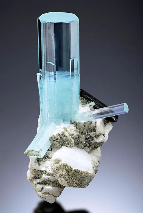 Close-up comparison of lighter and more saturated blue aquamarine stones